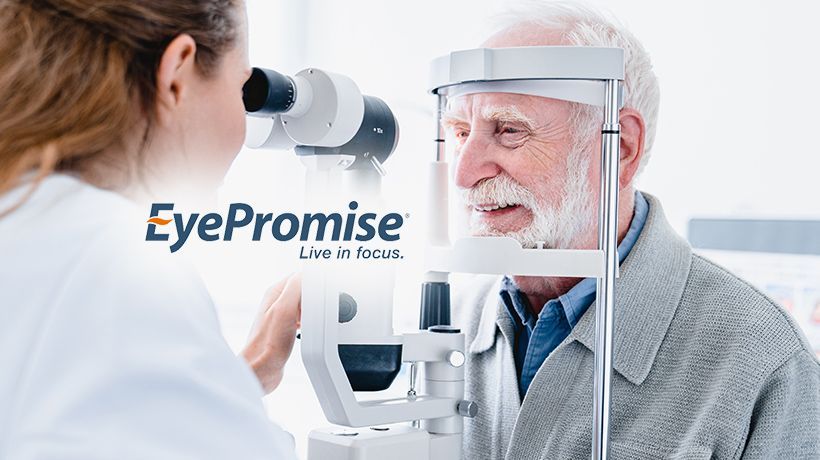 Eye exam at a clinic: optometrist using a slit lamp with an elderly man; EyePromise logo visible.
