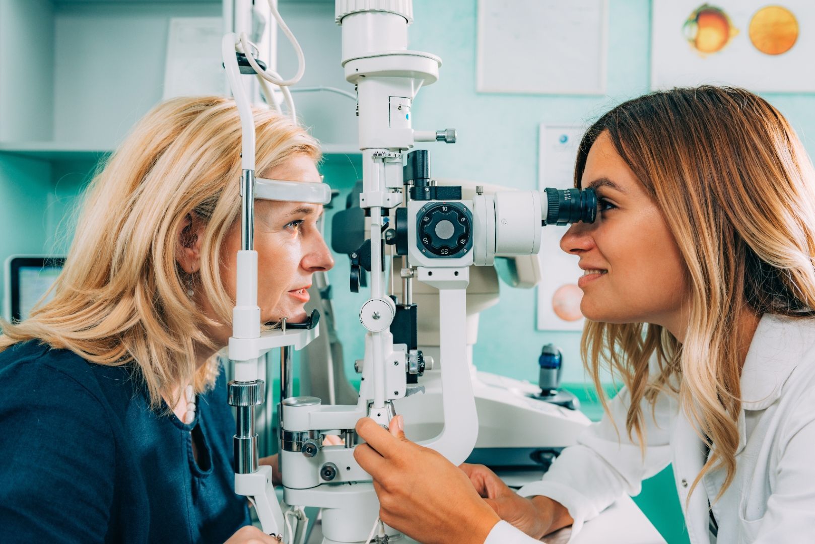 Optometrist taking time to explain eye exam results to a patient at Luxe Eye & Wellness