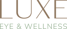 Lux Eye & Wellness logo in tan and green text on a white background
