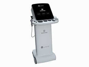 Doctor examining patient in a clinic room beside a medical imaging machine