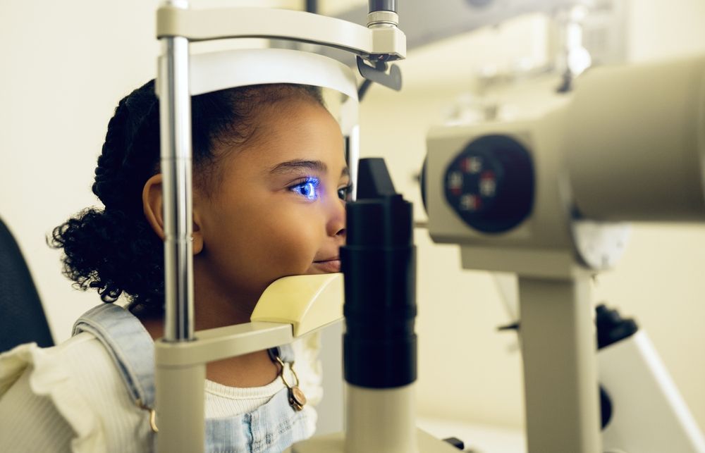 Person undergoing an eye exam at an optometrist’s machine