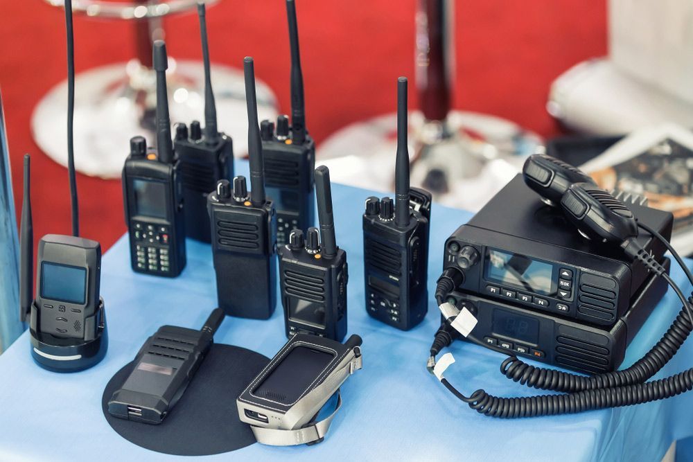 A Table Topped With A Variety Of Walkie Talkies — Tim Warren Auto Airconditioning & Electrical In Bowen, QLD