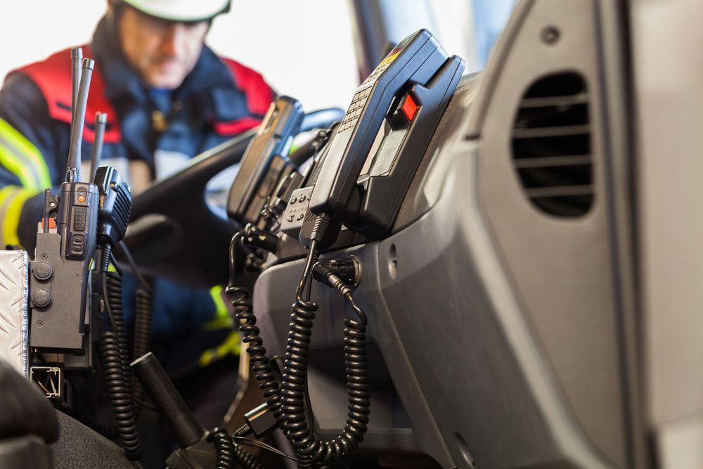 A Fireman Is Sitting In The Driver's Seat Of A Fire Truck — Tim Warren Auto Airconditioning & Electrical In Bowen, QLD
