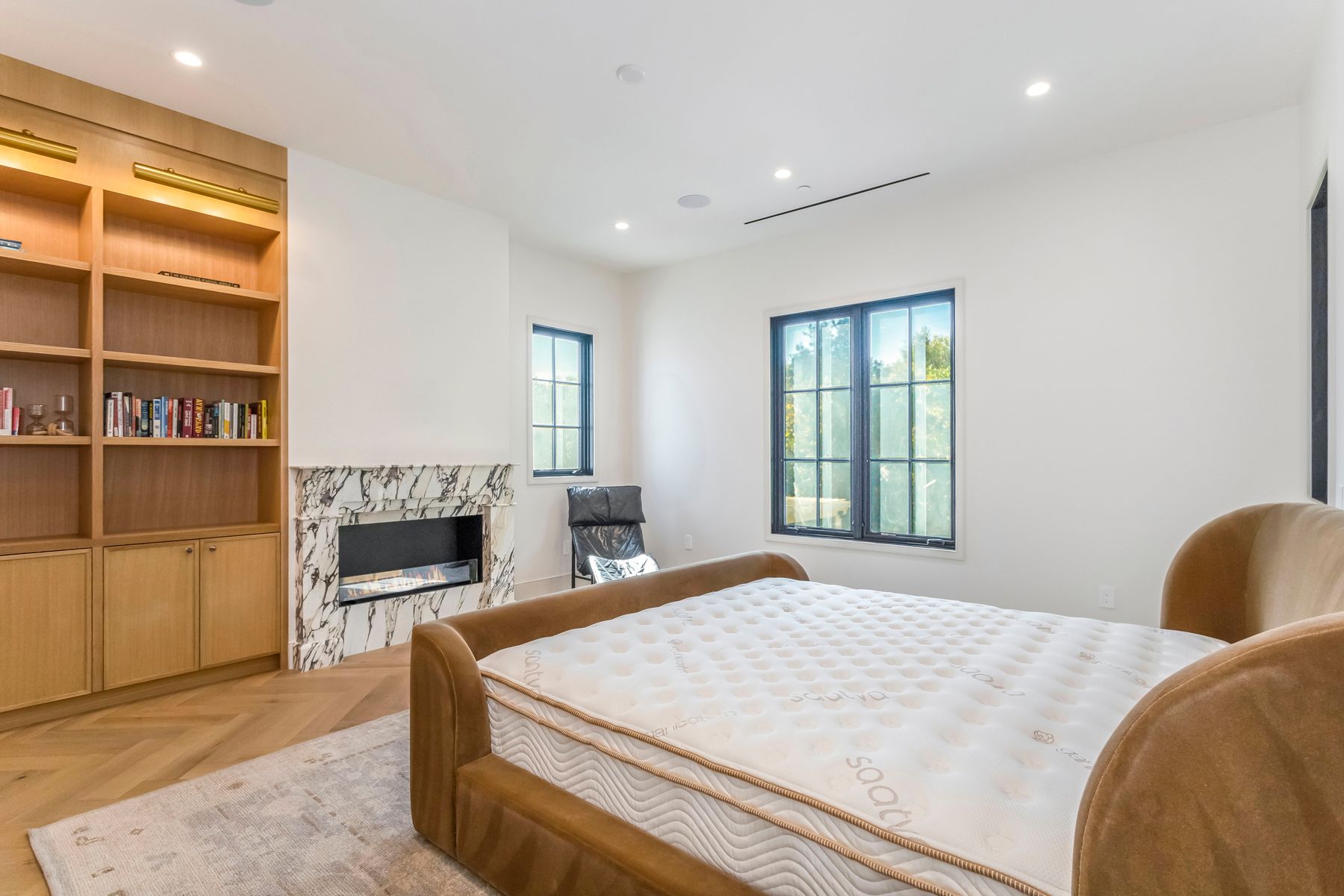 North Kenter avenue bedroom with fireplace and custom cabinetry