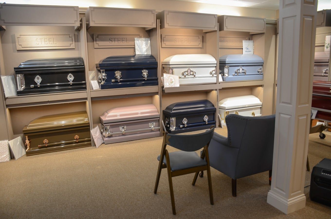 Furniture showroom with stacked sofas, chairs, and upholstered pieces in neutral tones