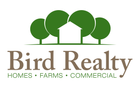 Bird Realty Logo of a house with trees surrounding it.