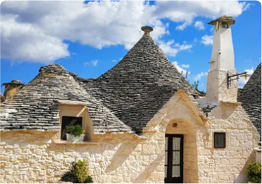 Traditional trulli stone houses with conical roofs in Alberobello, Italy.