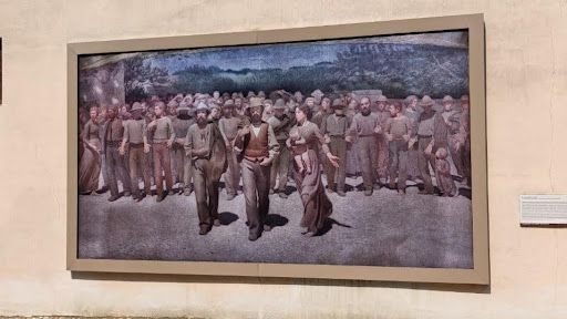Framed reproduction of 'Il Quarto Stato' depicting a workers' march.