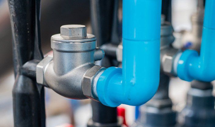 A close up of a blue pipe with a valve attached to it.