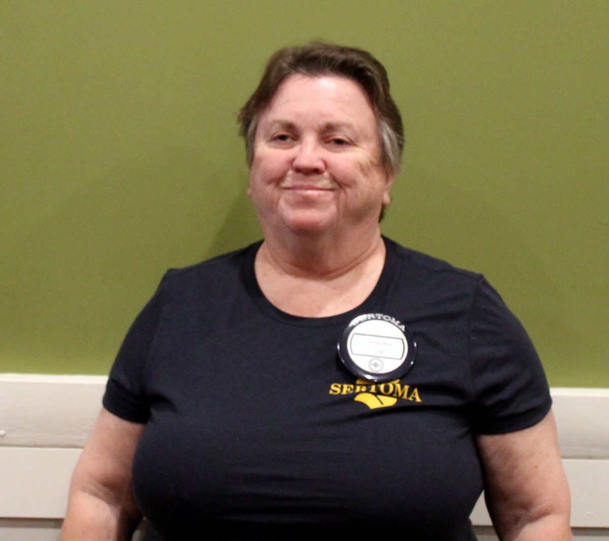 A man wearing a black shirt with the word digital on it