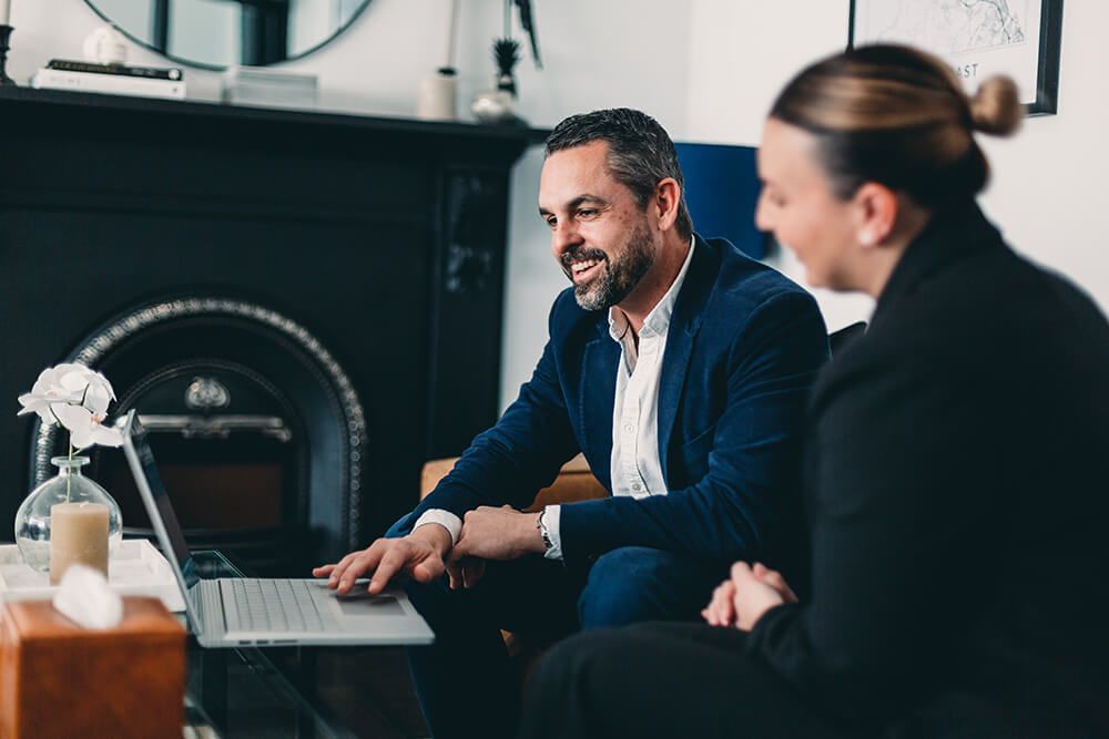 Man and a Woman Are Sitting in Front of a Laptop Computer — Slack-Smith Partners in Tamworth, NSW