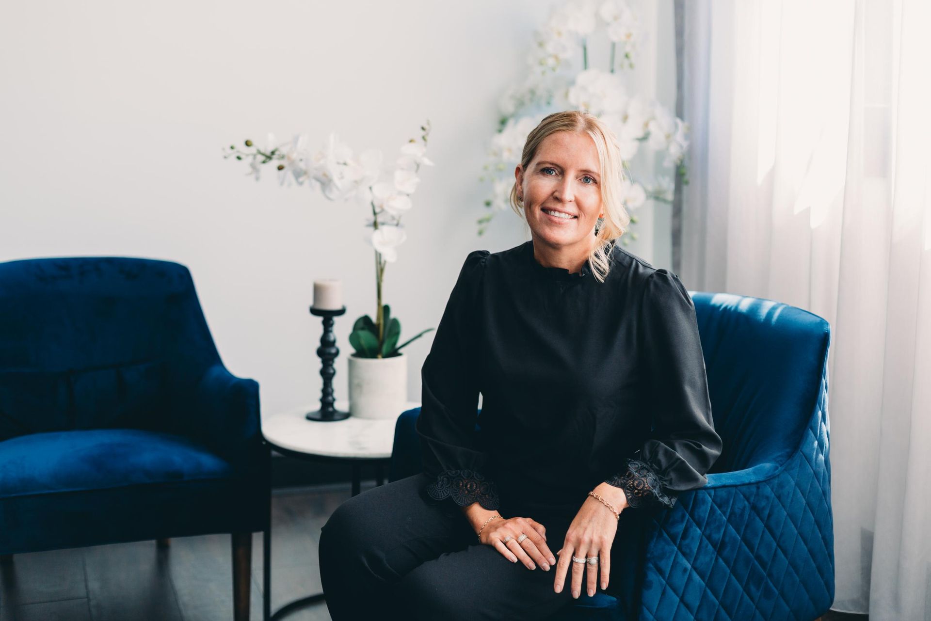 A Woman is Sitting in a Blue Chair in a Room — Slack-Smith Partners in Tamworth, NSW