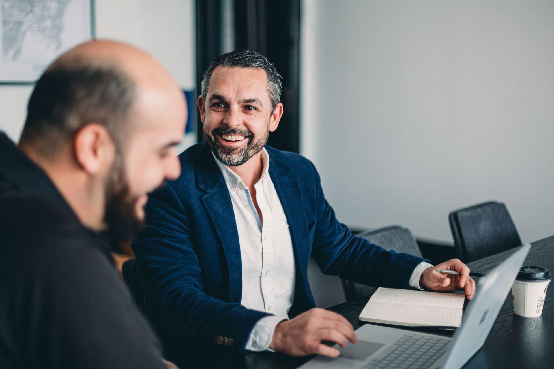 A Group of People Are Sitting Around a Table with Laptops — Slack-Smith Partners in Sydney, NSW