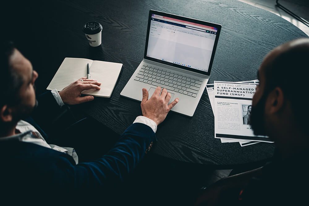 Two Men Looking at a Laptop Computer — Slack-Smith Partners in Tamworth, NSW