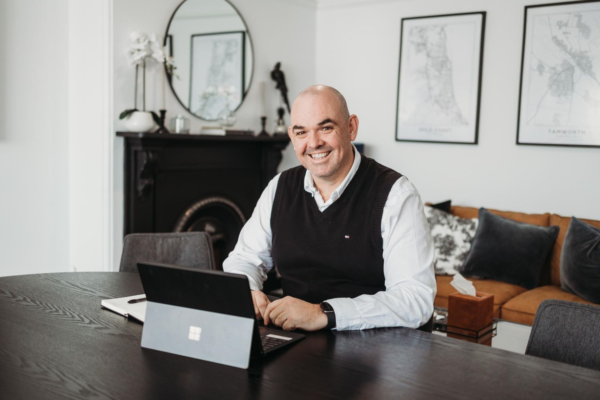A Man is Sitting at a Table With a Laptop on It — Slack-Smith Partners in Sydney, NSW