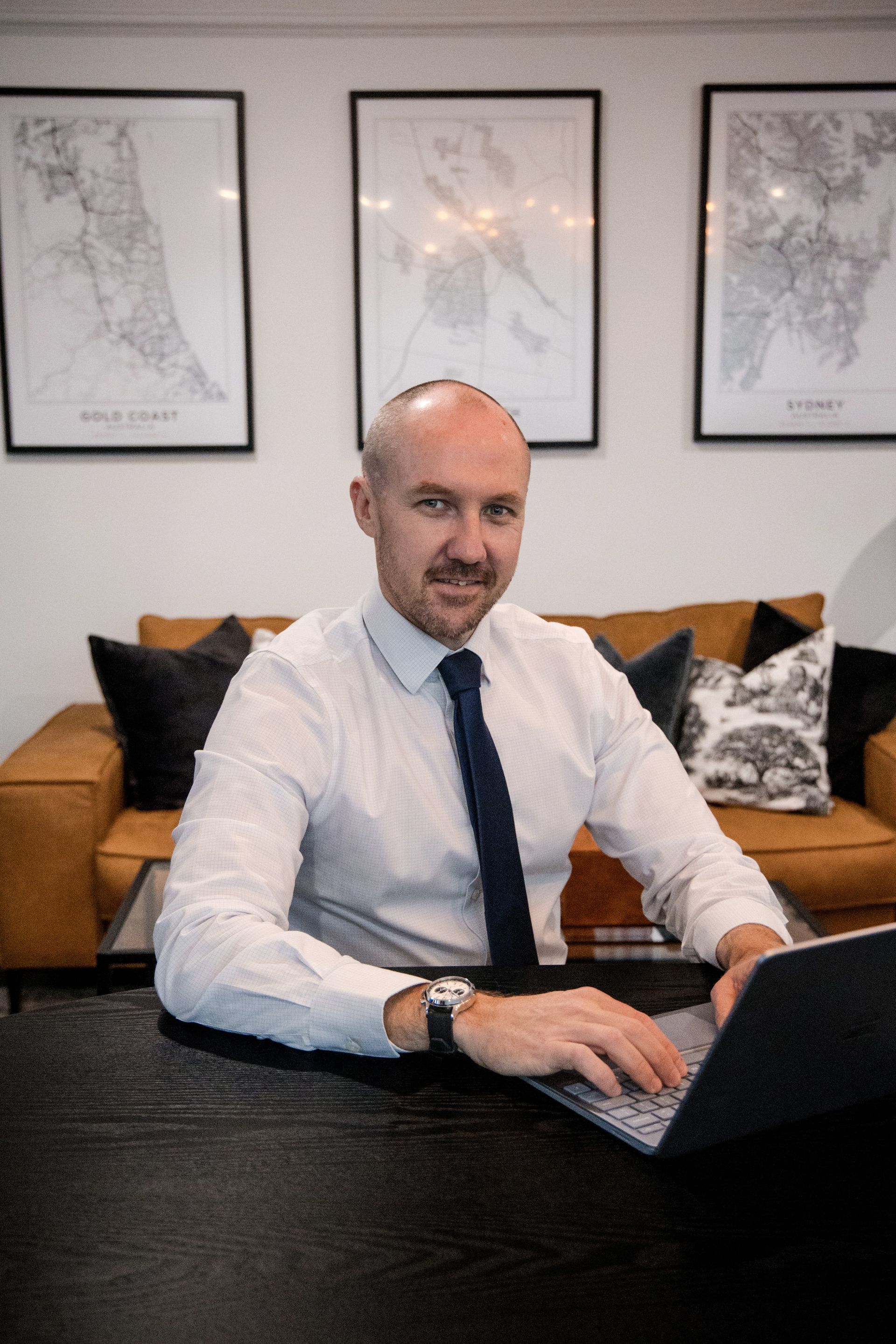 Man in White Shirt and Tie, Working on Laptop at Desk, Smiling — Slack-Smith Partners in Tamworth, NSW