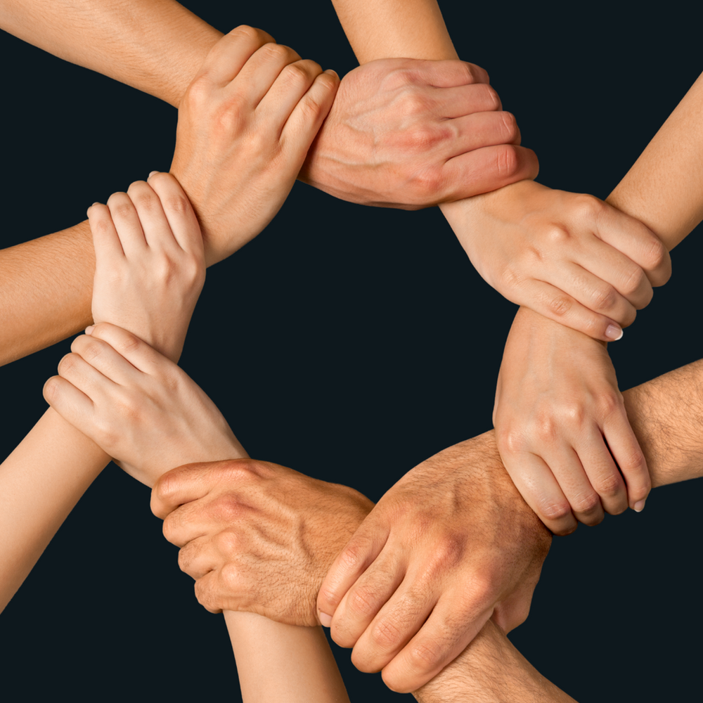 A Group of People Are Holding Hands in A Circle — Slack-Smith Partners  in Tamworth, NSW