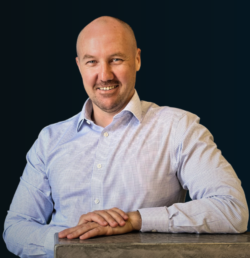 Smiling Bald Man in A Light Blue Striped Shirt — Slack-Smith Partners in Tamworth, NSW