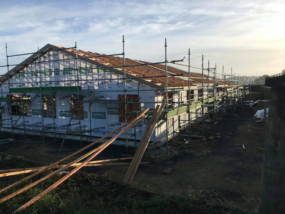 Building under construction with scaffolding and a partially completed roof. Building under construction with scaffolding and a partially completed roof.