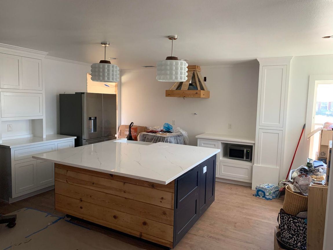 A kitchen with a large island in the middle of the room.