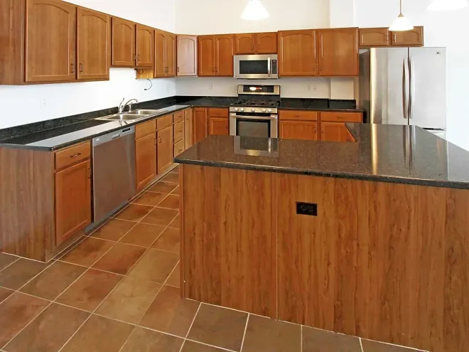 A kitchen with stainless steel appliances and wooden cabinets