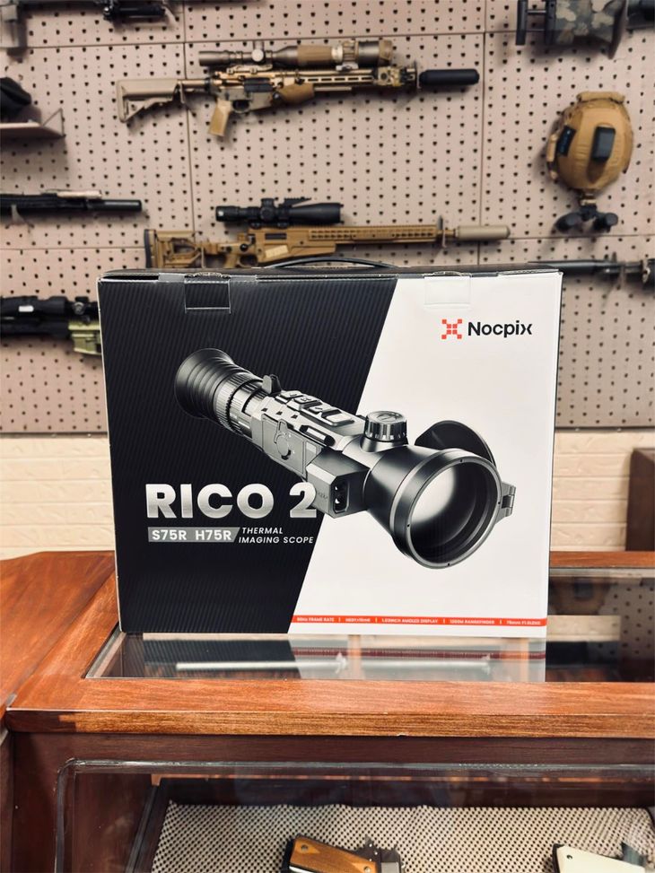 Sightmark RICO 2 thermal scope box displayed on a wooden table in a gun shop