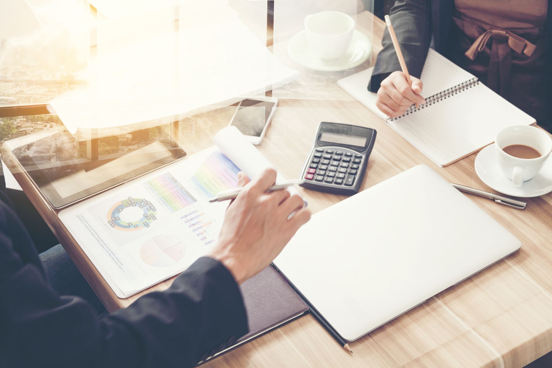 A Man and a Woman Are Sitting at a Table With a Laptop and a Calculator — Murphy Finance Solutions In Zuccoli, NT