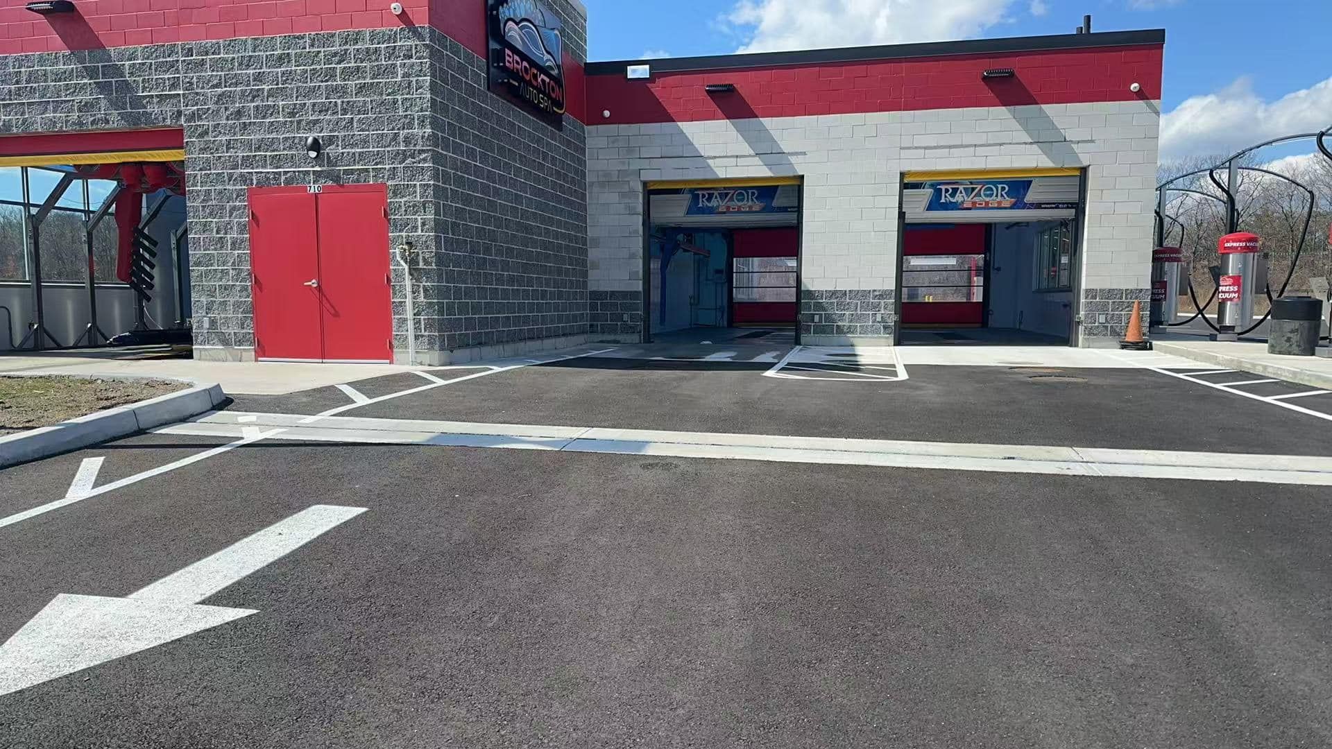 A car wash with a parking lot in front of it.