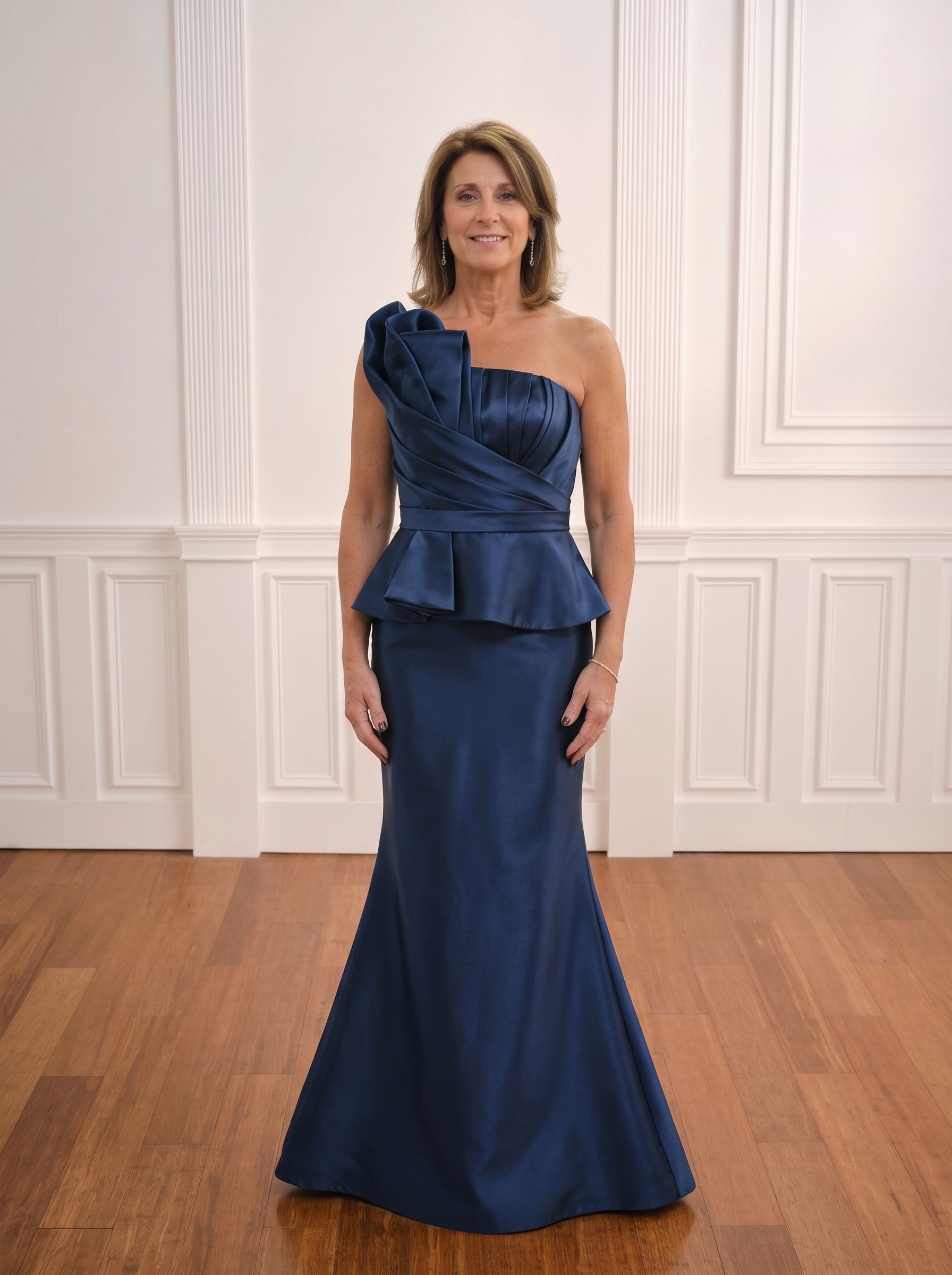 Woman in a navy one-shoulder gown standing in a white-paneled room with wood floors.