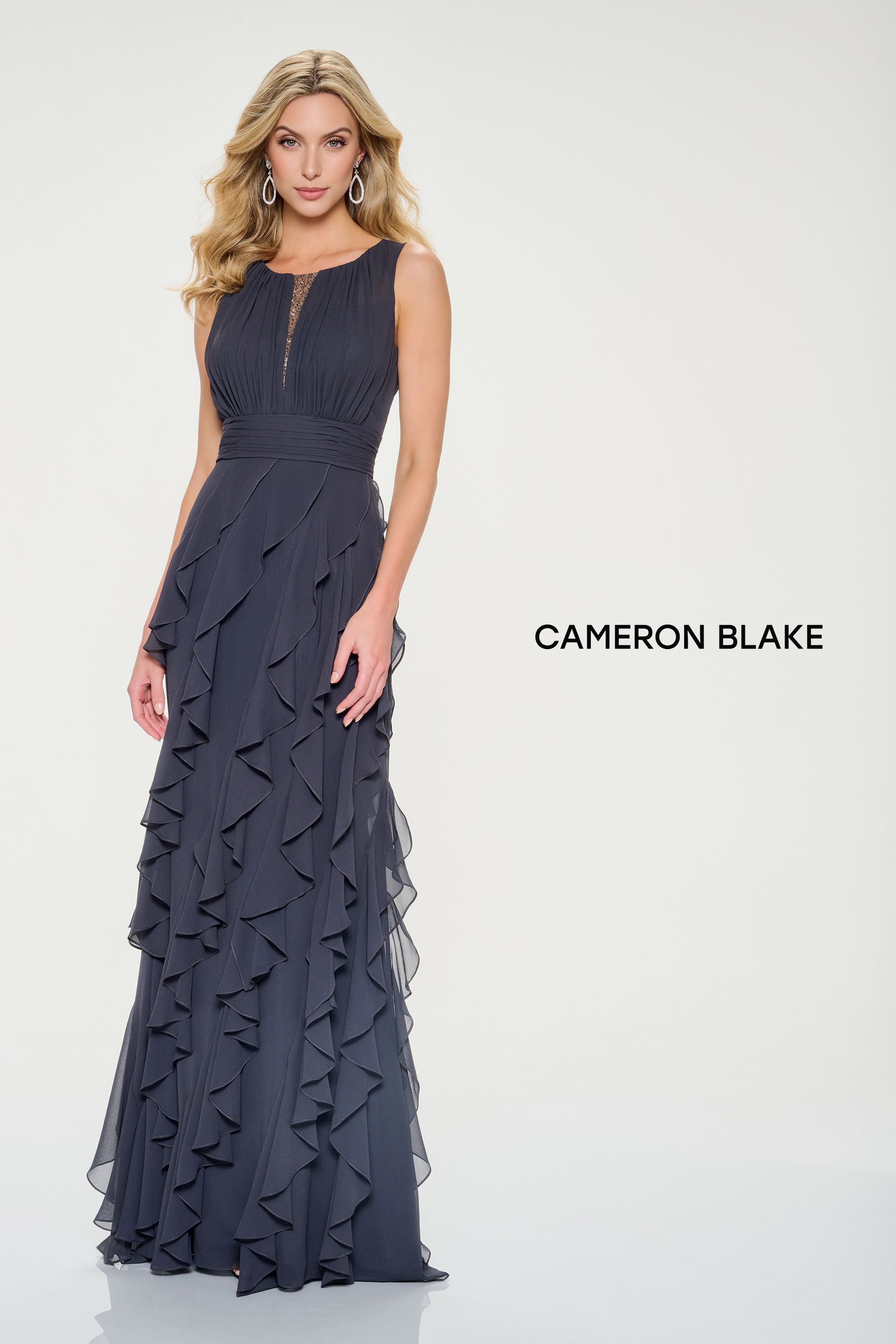 Woman in a navy blue formal dress with ruffles; the dress is floor-length.