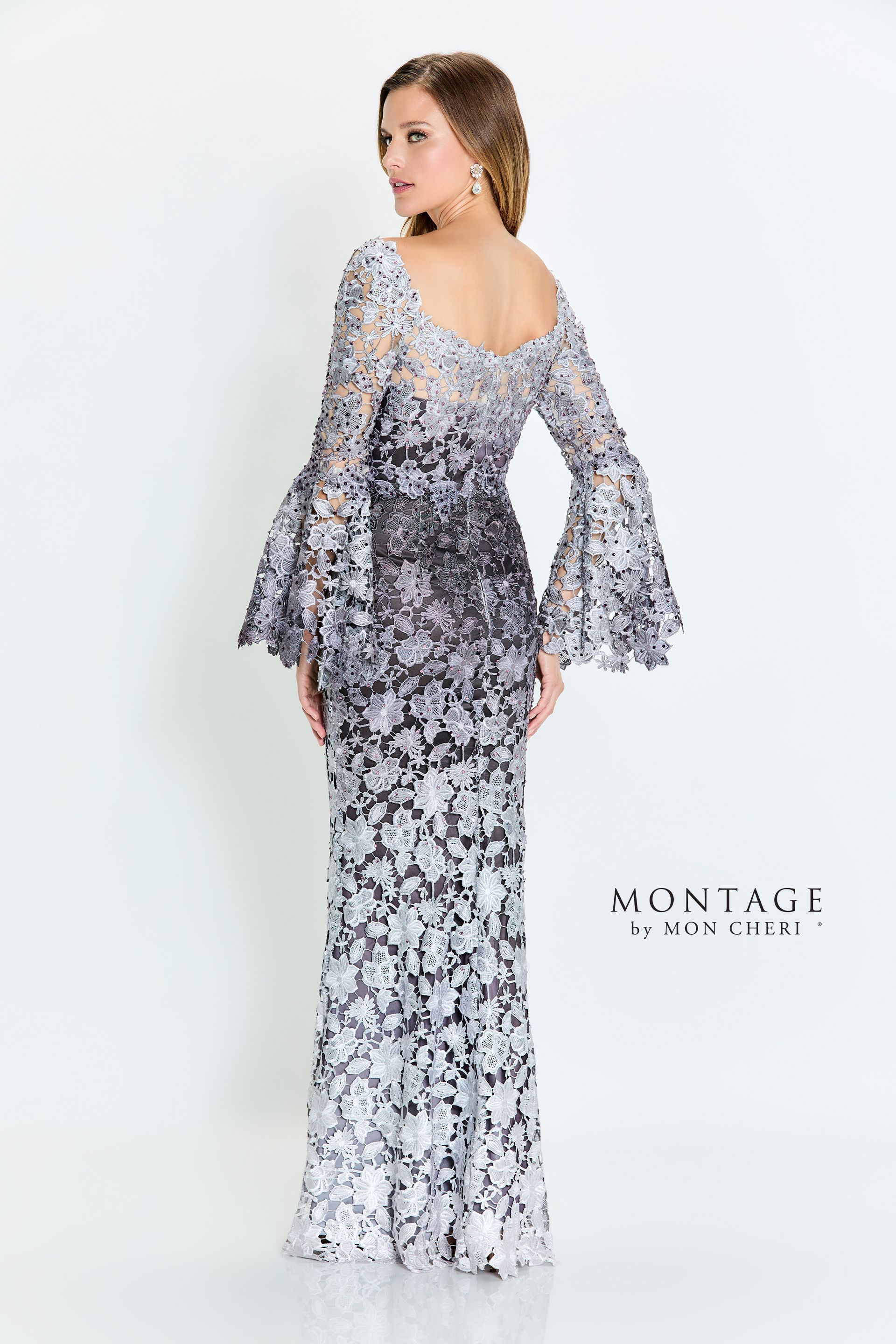 Woman in formal, sequined gown with bell sleeves, standing in a studio, looking over her shoulder.