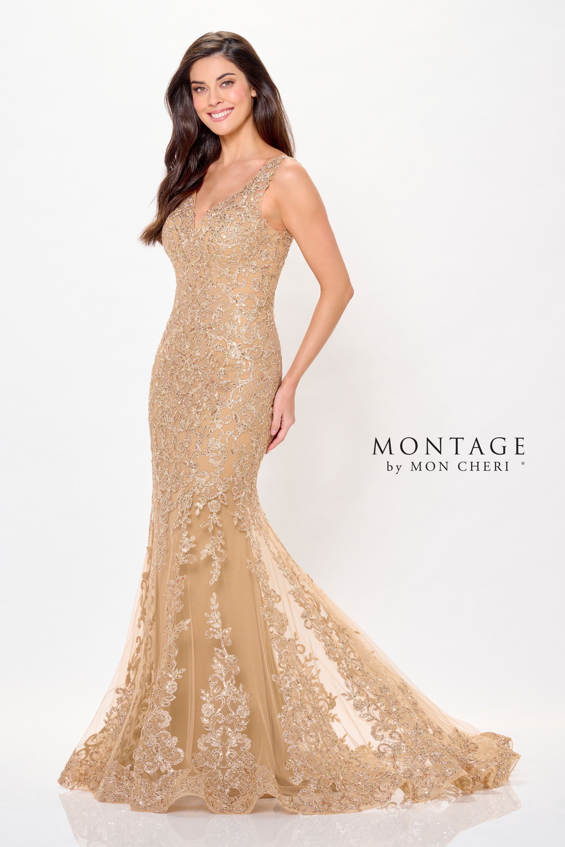 Woman in a gold, beaded evening gown with a plunging neckline, posing against a white background.