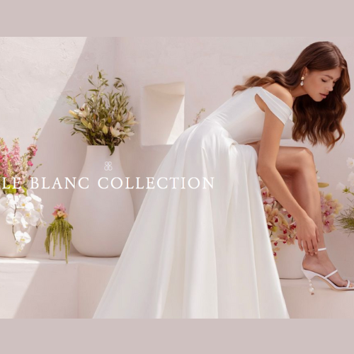 Woman in white off-the-shoulder dress adjusts her shoe. Le Blanc Collection text is visible. Flowers decorate the setting.