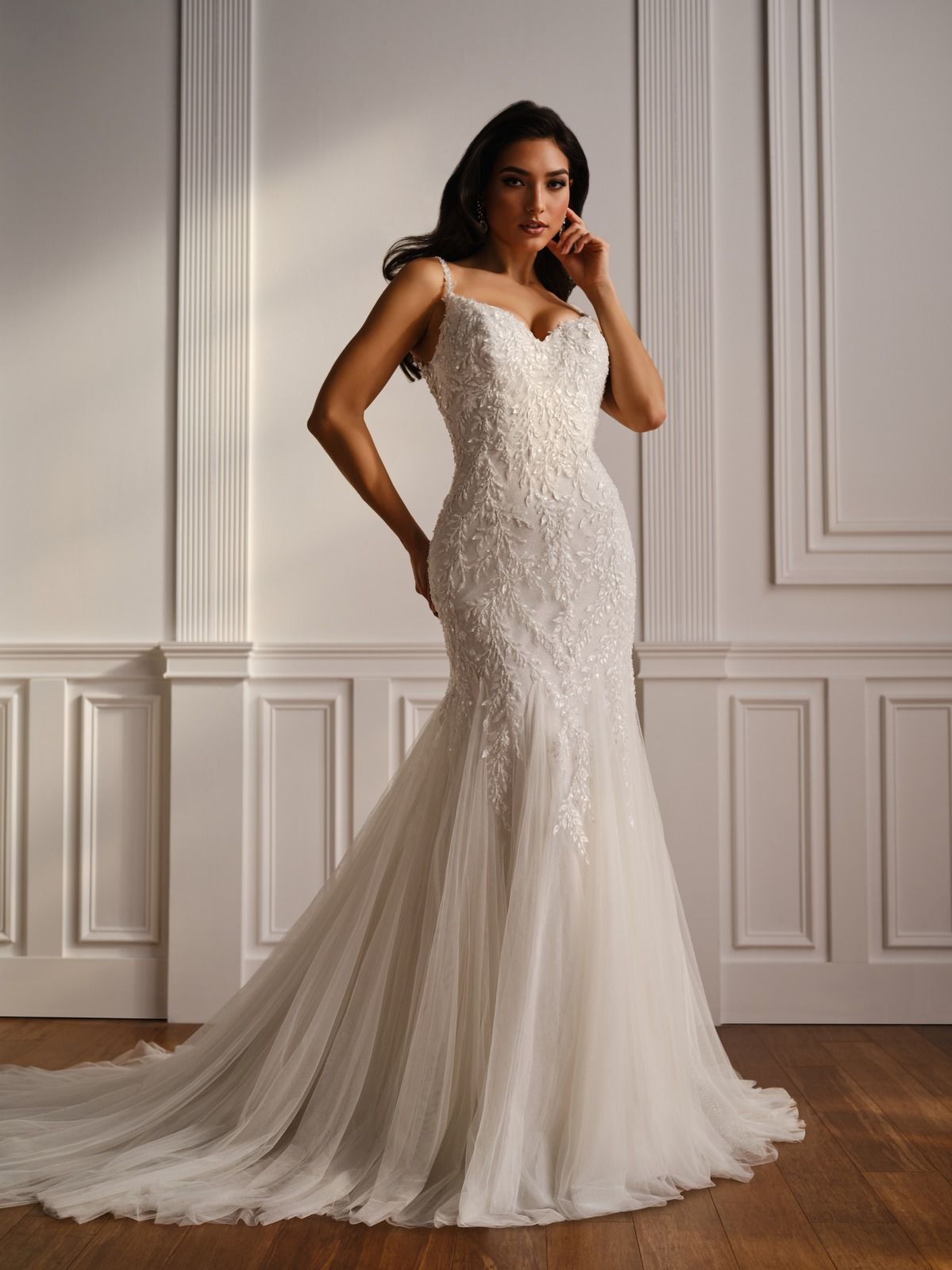 Woman in a white lace wedding gown posing in a paneled room.