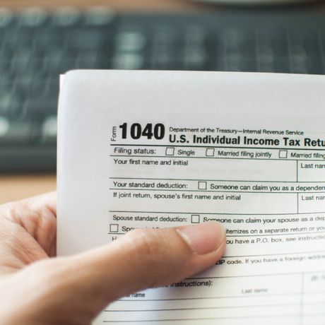 Man Holding a Tax Form – Whittier, CA – EM Bookkeeping and Tax Service