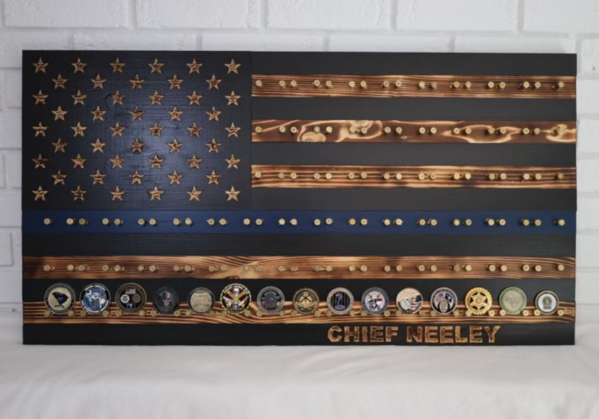 Wooden American flag plaque with police challenge coins and the name