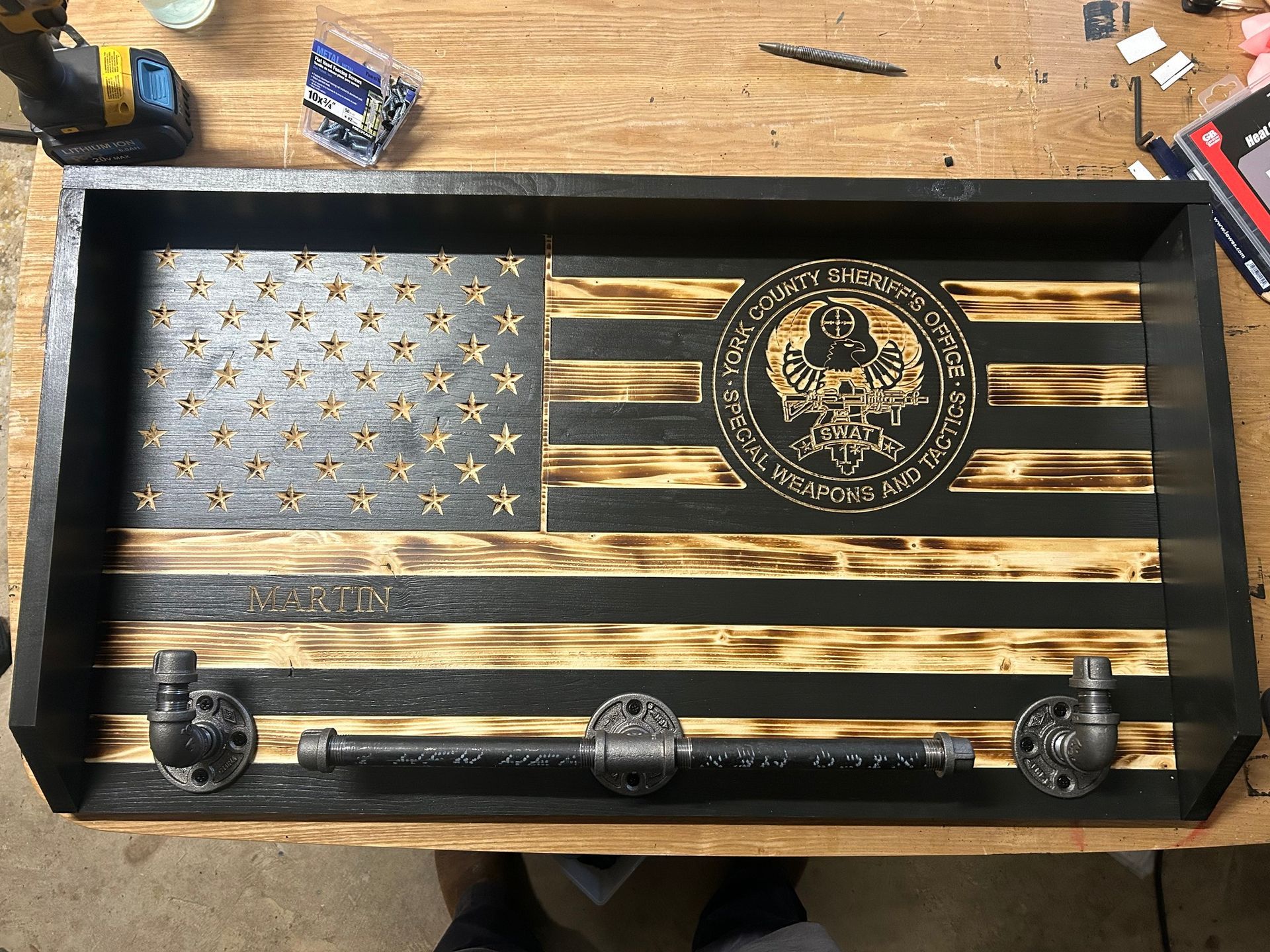Wooden American flag with emblem, pipe towel bar.