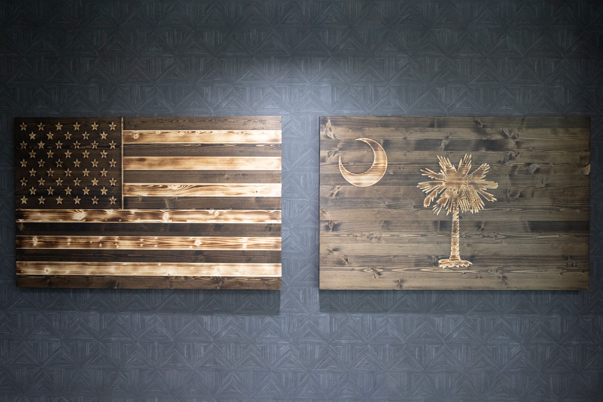 Two rustic wooden wall art pieces: an American flag and a crescent moon with a tree silhouette