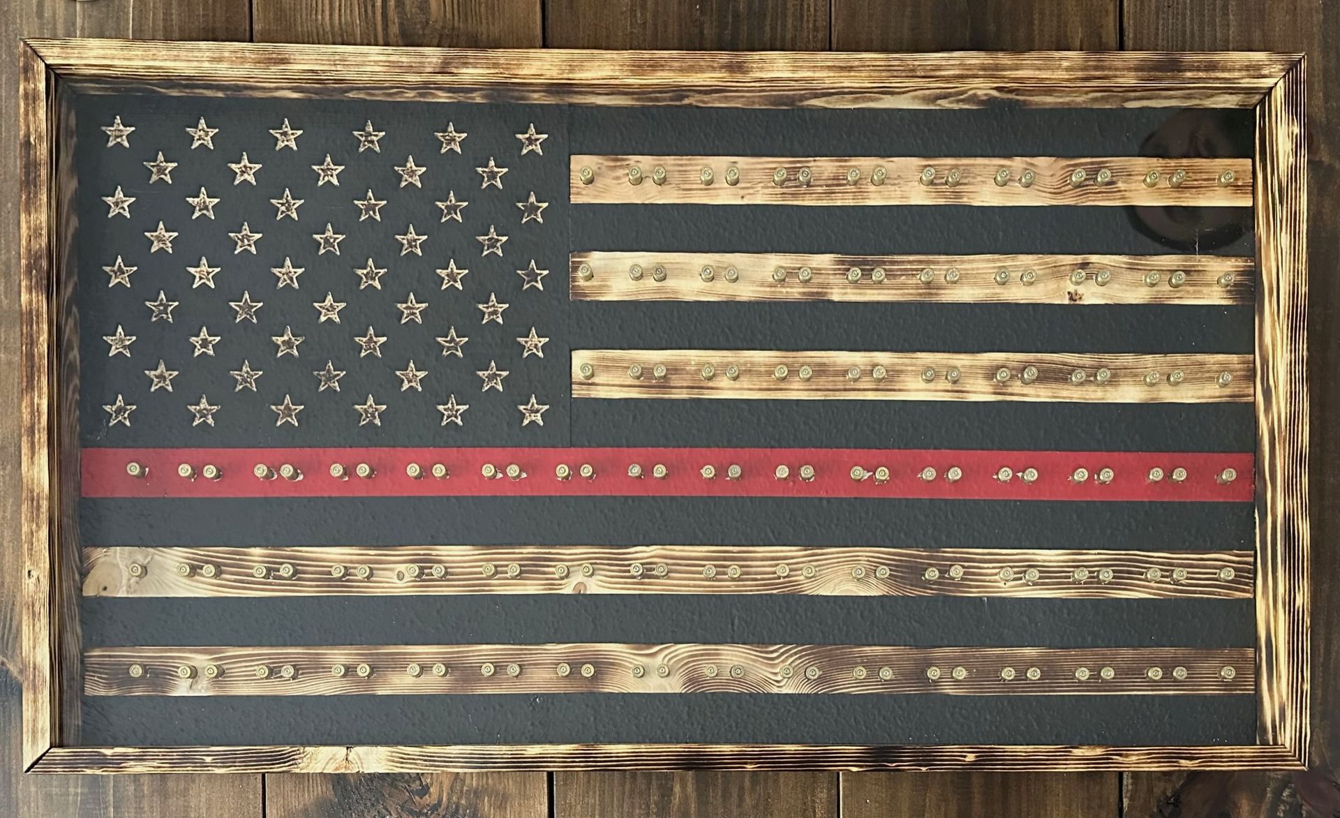 Wooden American flag with a red line for firefighters, framed in wood.