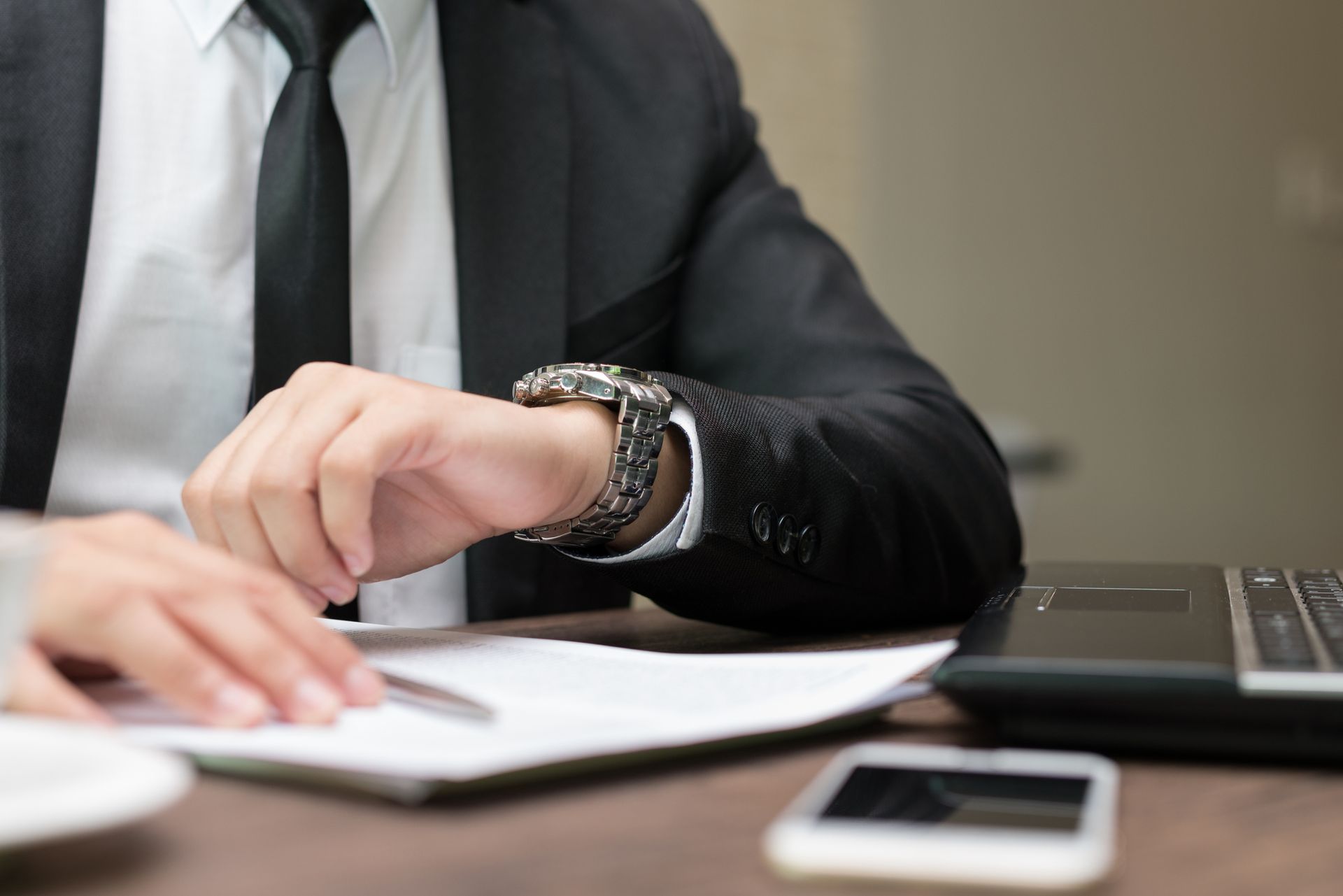 A man is looking at his watch