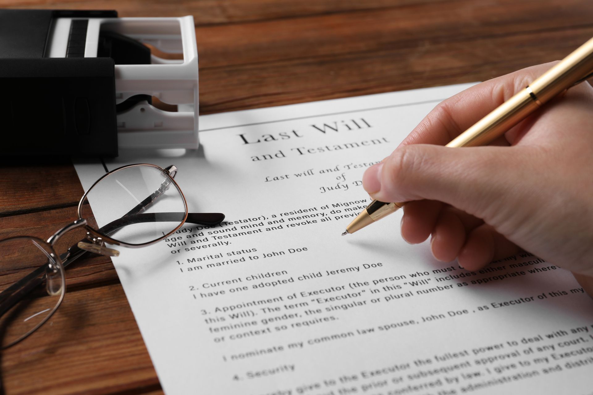 A woman reviewing and signing her last will and testament.
