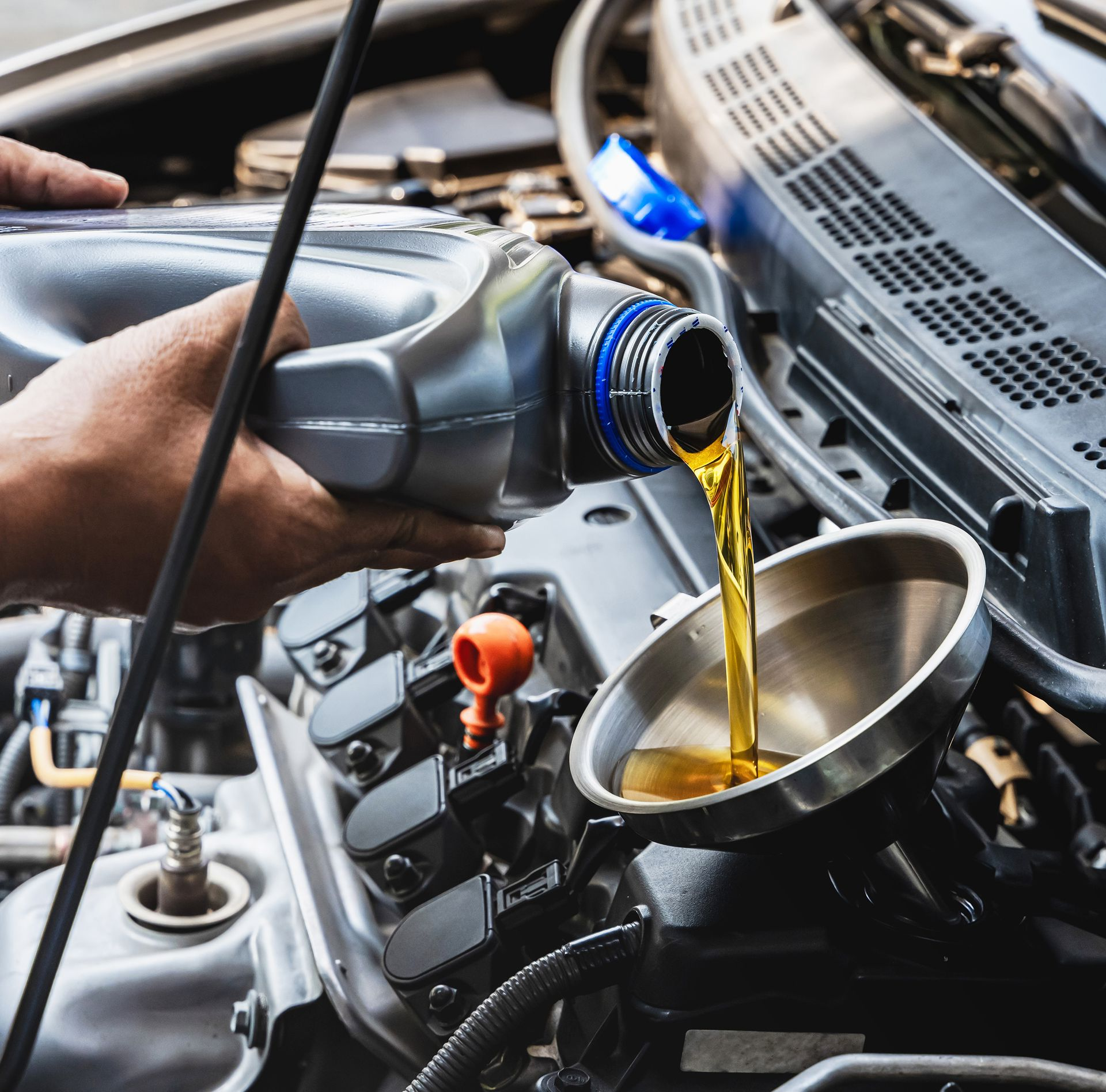 A Mechanic Changing the Oil in a Car — ATD Automotive in North Wollongong, NSW