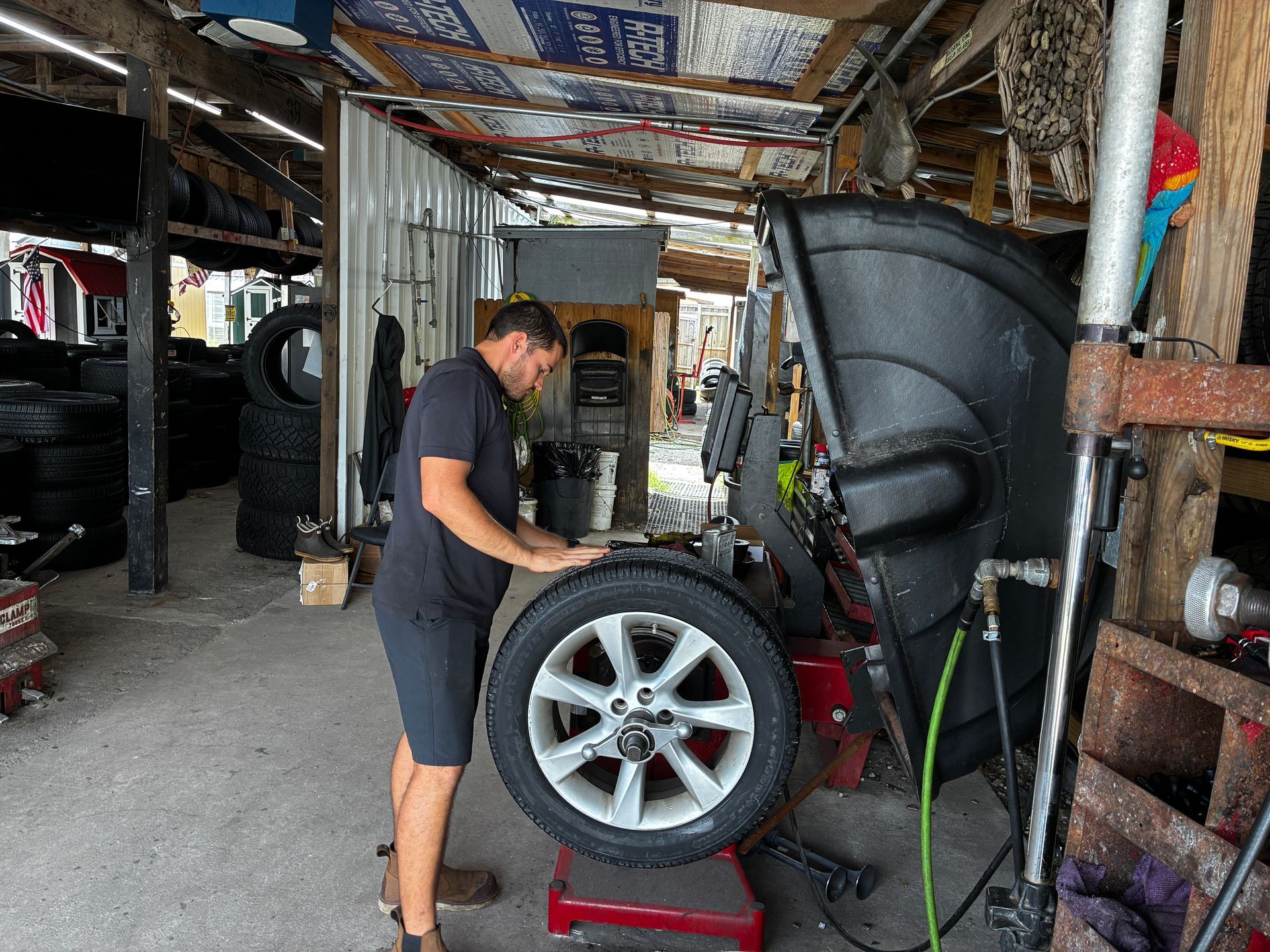 Tire technician examining a tire in a shop