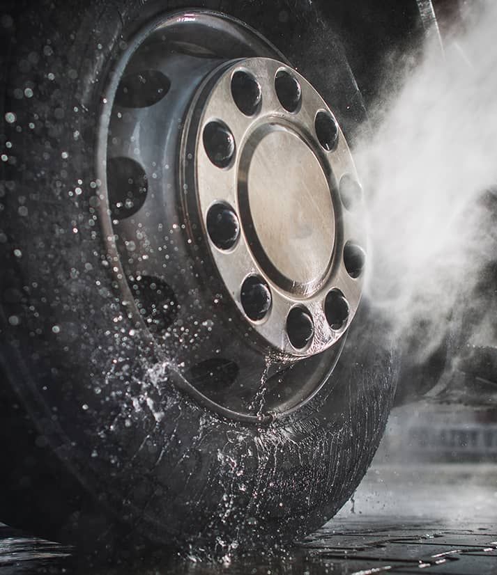 A close up of a tire with steam coming out of it