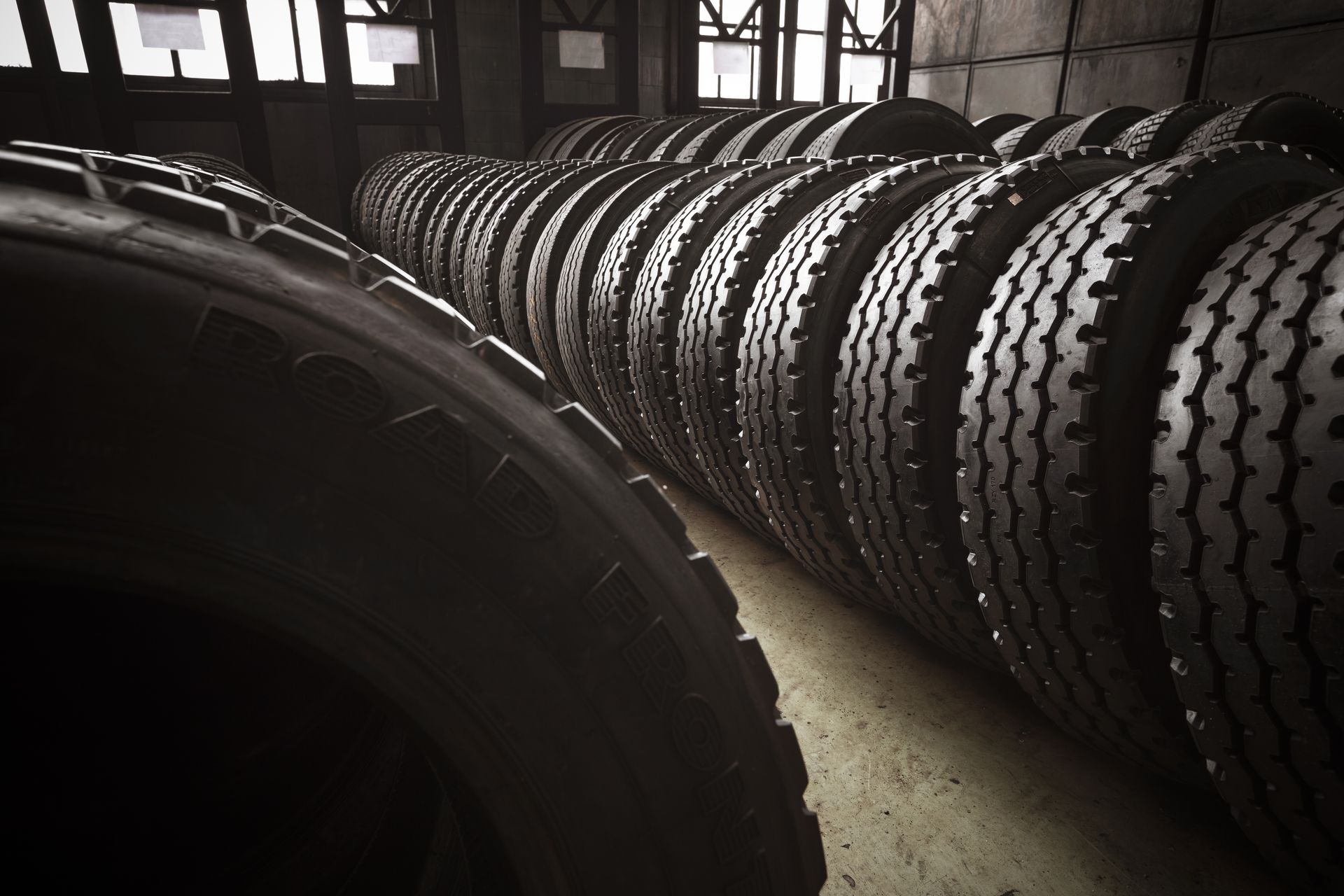 A warehouse filled with lots of tires stacked on top of each other.