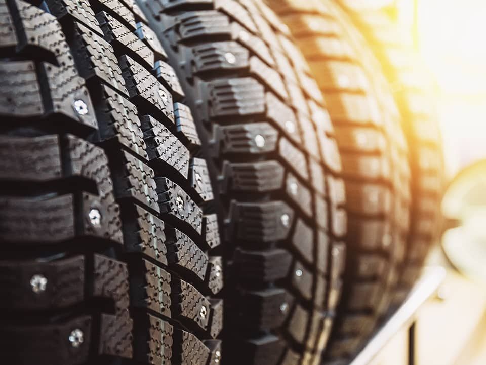 A close up of a stack of tires with spikes on them.