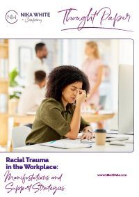Cover of a thought paper. Woman at desk, face in hand, looking stressed. Other people in the background. Title: Racial Trauma in the Workplace.