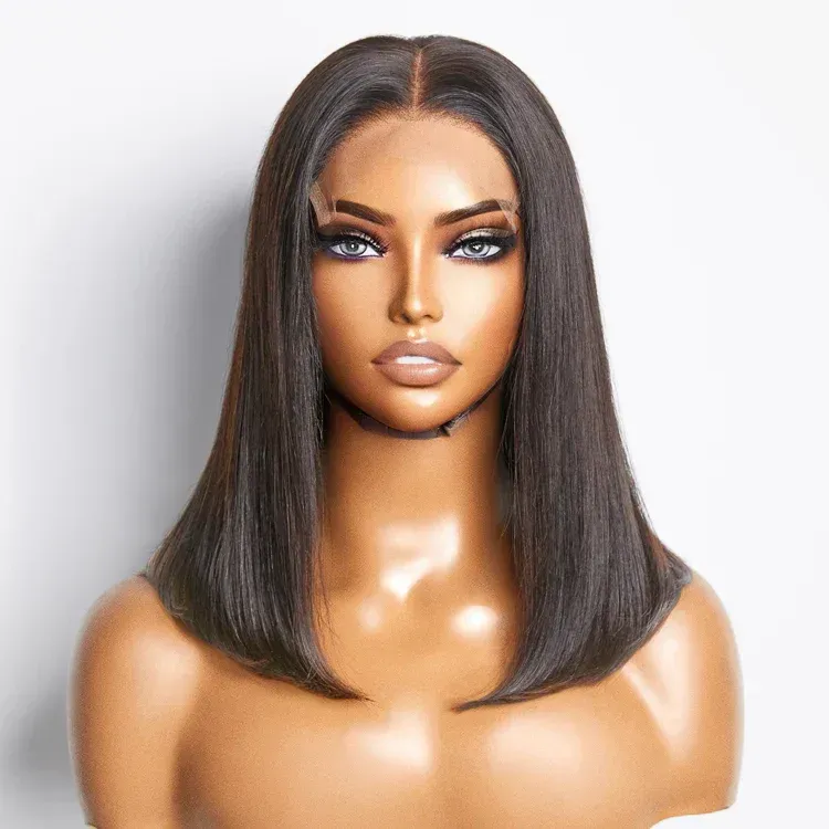 Woman wearing a dark-haired bob wig with a center part; neutral expression, studio setting.