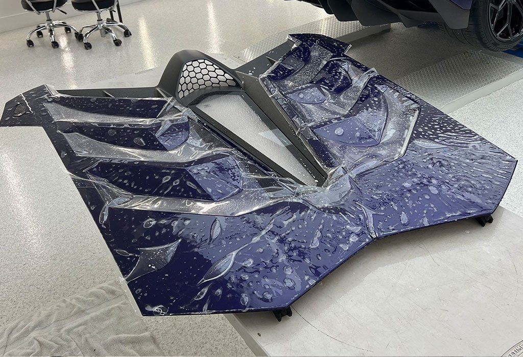 A blue and gray object is sitting on a white floor