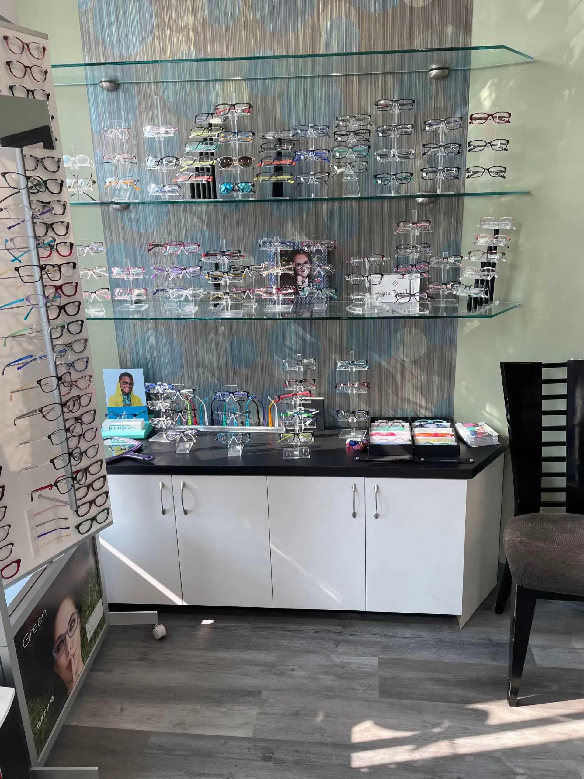 There are many different types of glasses on the shelves in this room.